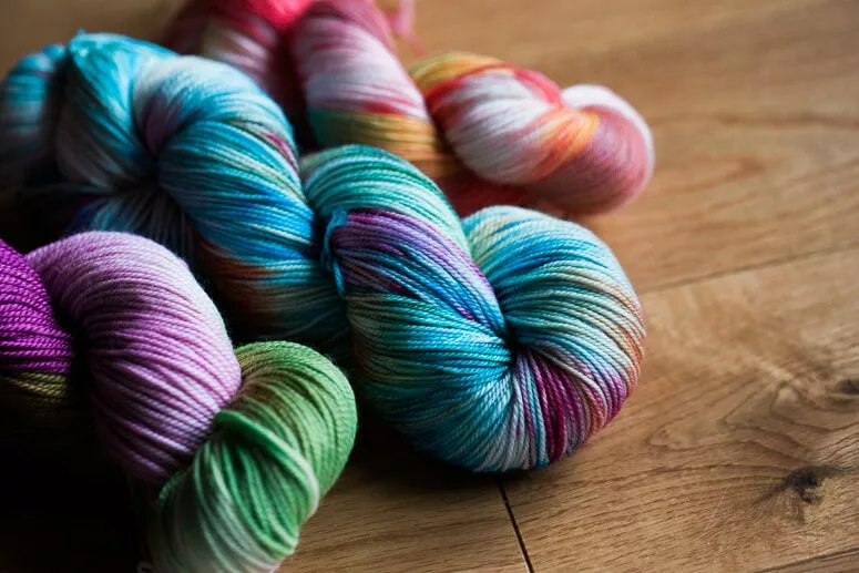 These skeins were all dye demonstrations. From left to right: handpainting, low-water immersion, and Kool Aid techniques