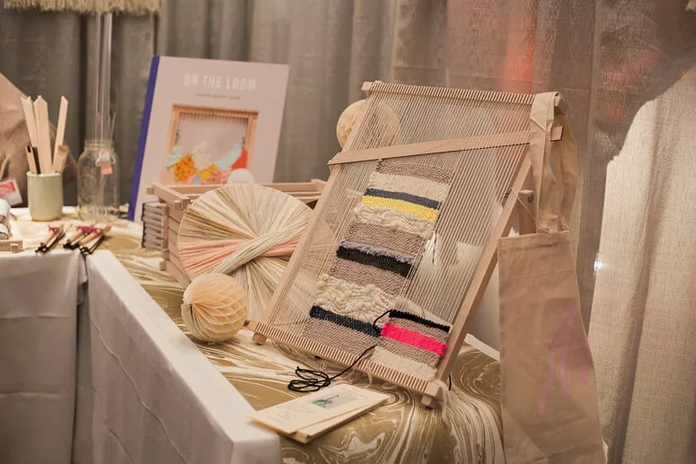 Maryanne Moodie's booth at VKLive, filled with frame looms and weaving