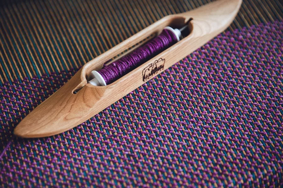 Schacht boat shuttle on handwoven cloth