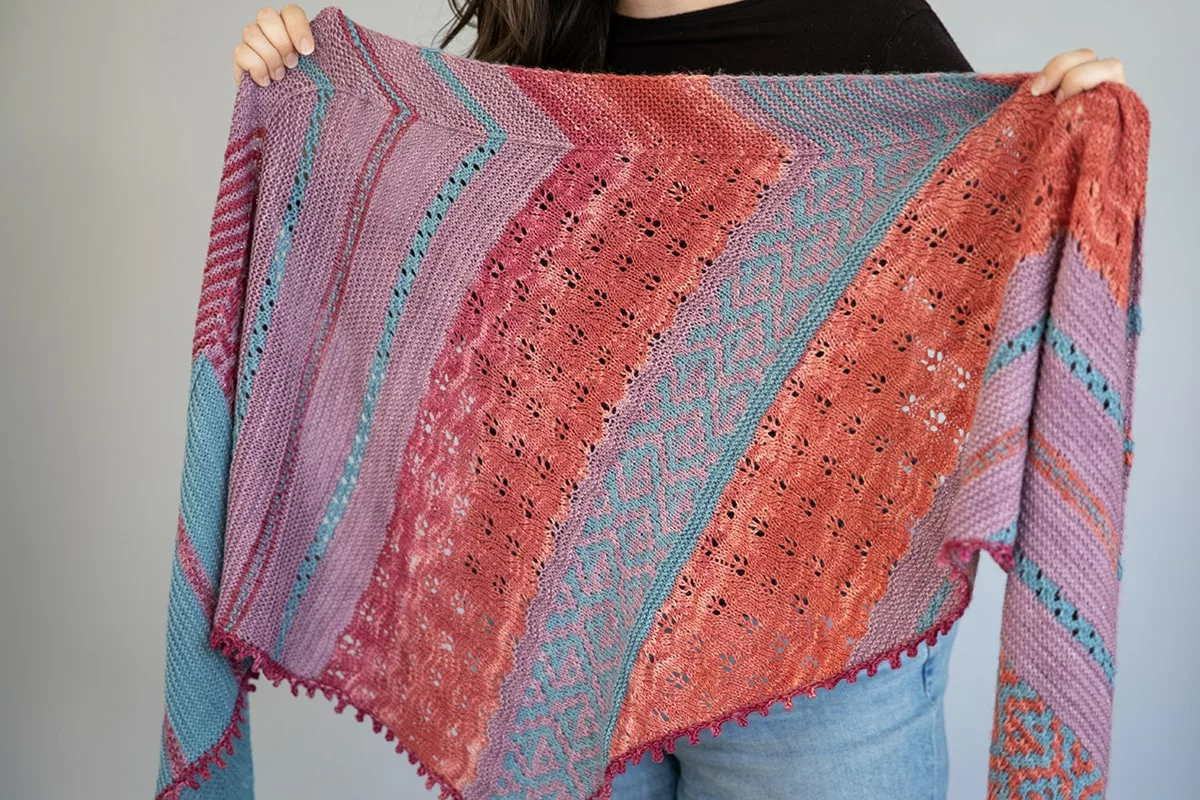 Autumn Dahlias mystery knit shawl knitting pattern by Tabetha Hedrick, with red, blue, and purple colours