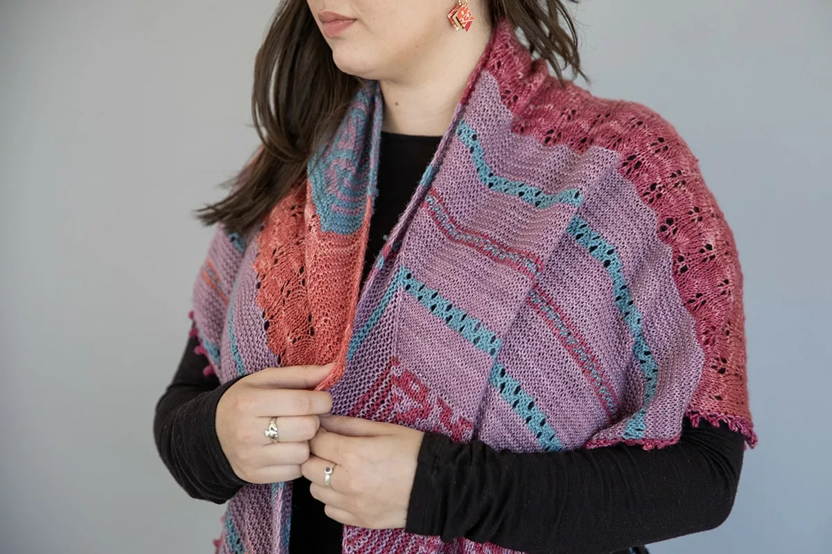 Autumn Dahlias mystery knit shawl knitting pattern by Tabetha Hedrick, with red, blue, and purple colours