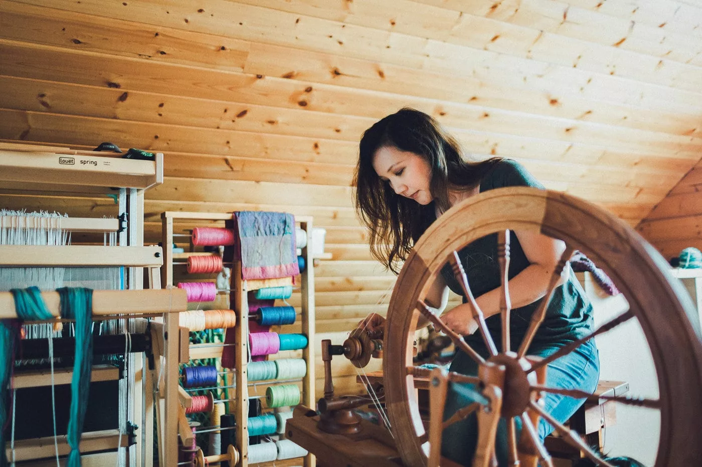 Felicia at the spinning wheel (photo by Josh Yong)