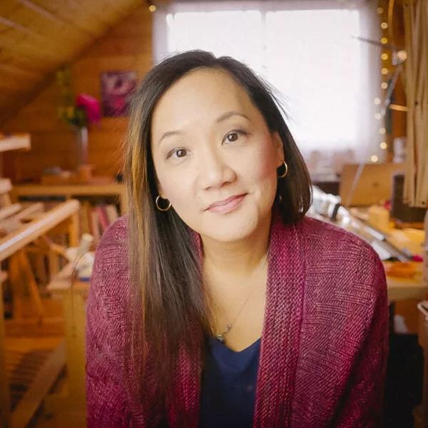 Felicia Lo Headshot, sitting in craft room attic