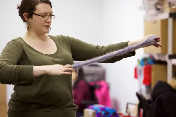 Ginny twisting yarn to make a twisted skein.