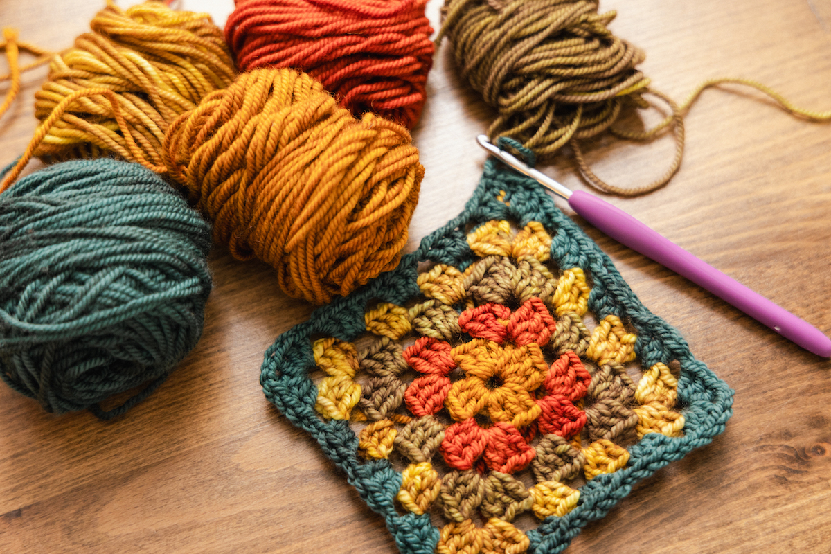 Crochet granny squares for making Tanis Fiber Arts Jethro cardigan using hand-dyed SweetGeorgia mini-skein yarn