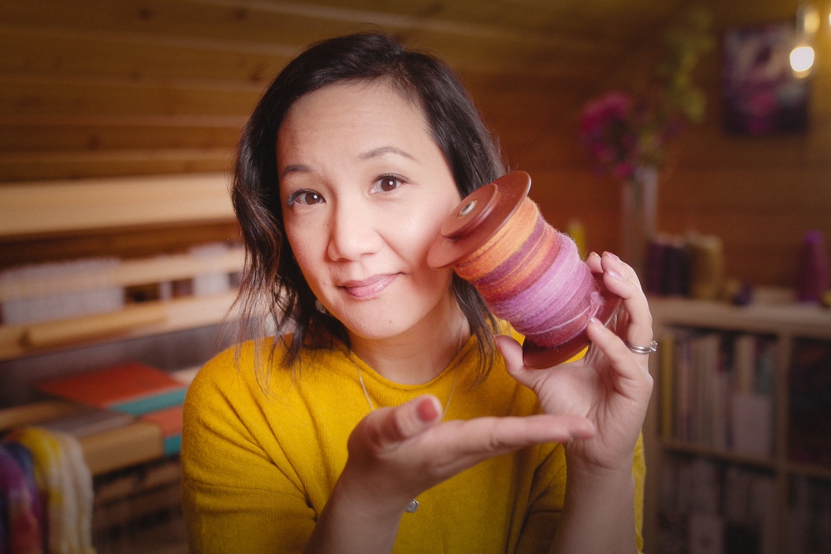 Felicia Lo on Taking Back Friday vlog holding handspun singles from Tour de Fleece