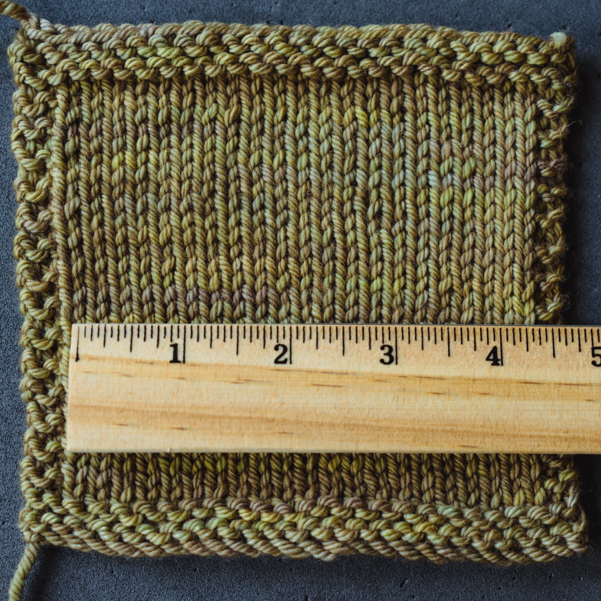 Hold the ruler horizontally and count the number of stitches in four inches.