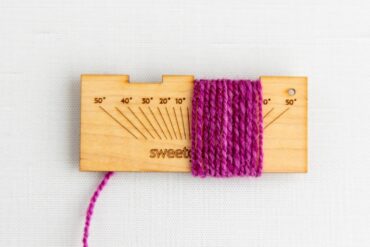 Measuring yarn on the SweetGeorgia Gauge WPI spinning tool.