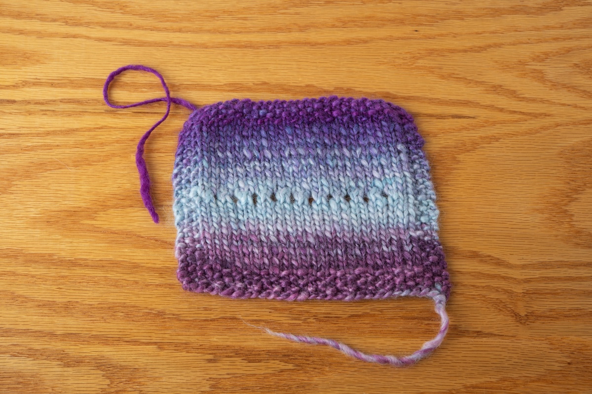 Single-ply yarn knitted into a swatch. 
