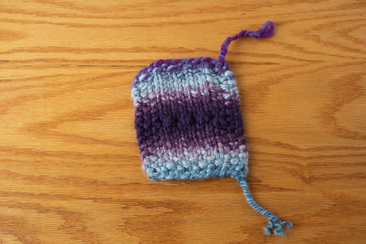 A 3-ply yarn knitted into a swatch. 