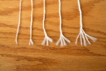 yarns in a lineup, each unravelled to expose the yarn plies.