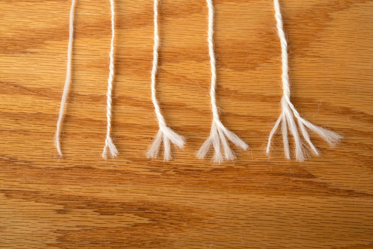 yarns in a lineup, each unravelled to expose the yarn plies. 