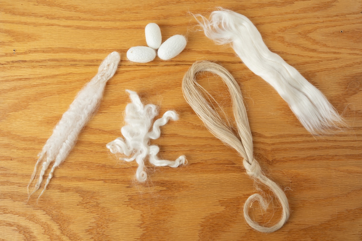 From left to right: wool, hair, silk (as a cocoon), cellulose, and man-made.