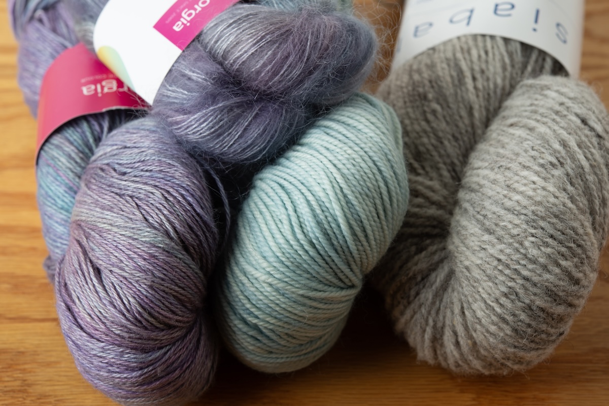 a lineup of different yarns showing off how different they all look. 