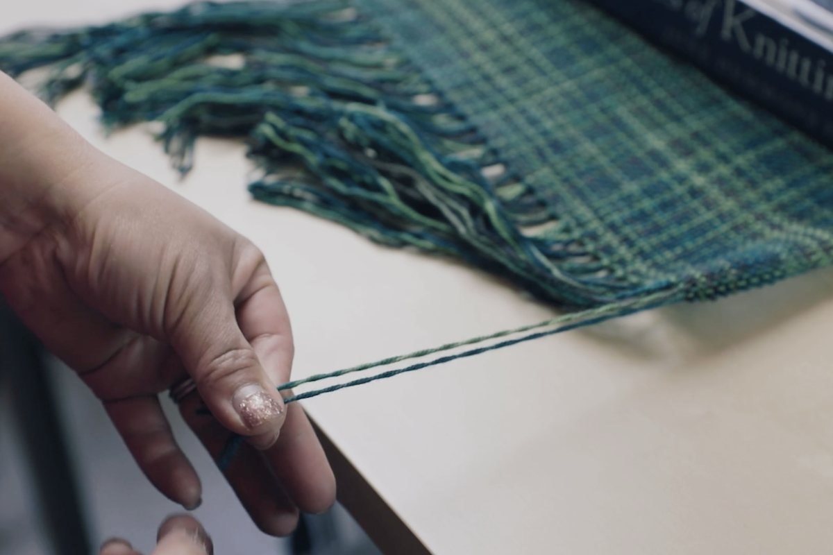 Twisting the ends of a handwoven scarf by hand 