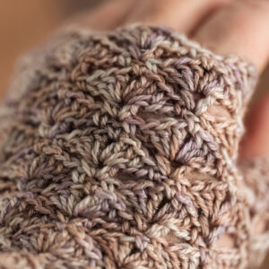 Crochet fingerless gloves in Secret Stash Club colourway for December 2024