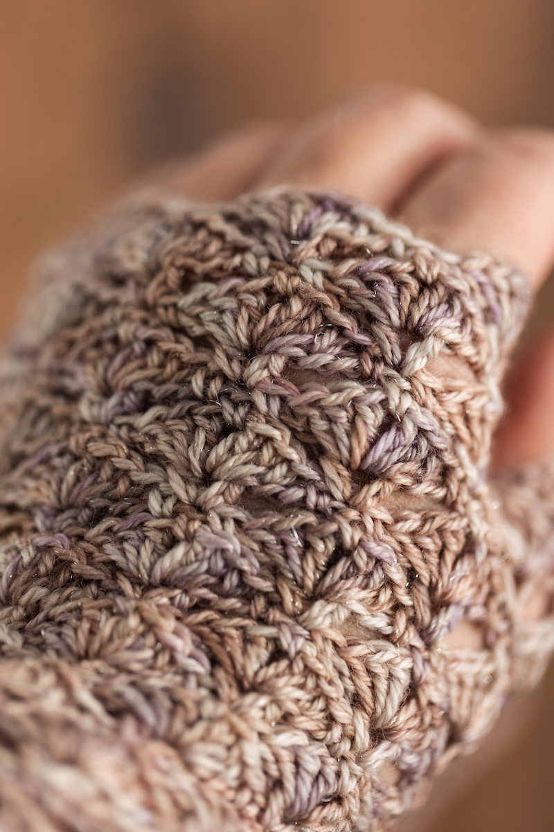 Crochet fingerless gloves in Secret Stash Club colourway for December 2024