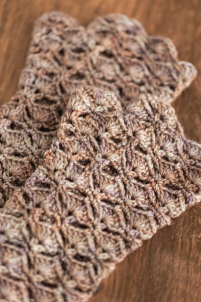 Crochet fingerless gloves in Secret Stash Club colourway for December 2024
