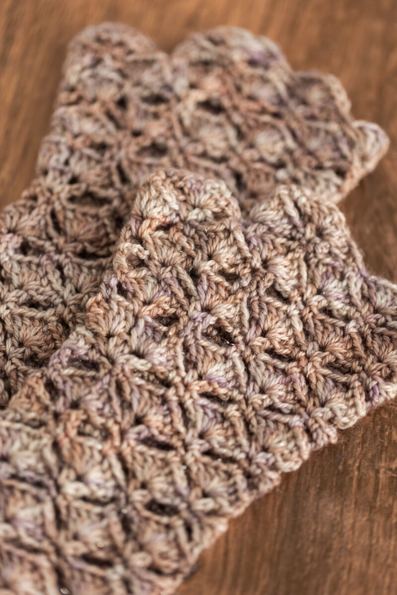 Crochet fingerless gloves in Secret Stash Club colourway for December 2024