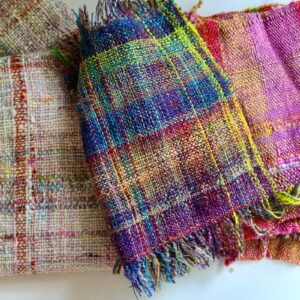 Handwoven scarves that have been made with handspun yarn.