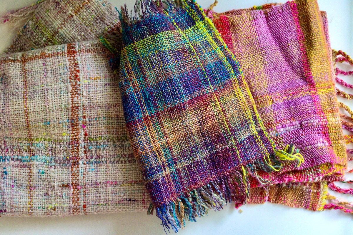 Handwoven scarves that have been made with handspun yarn.