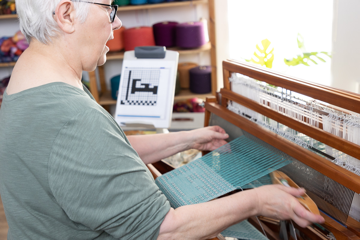 Laura Fry sitting at the loom 