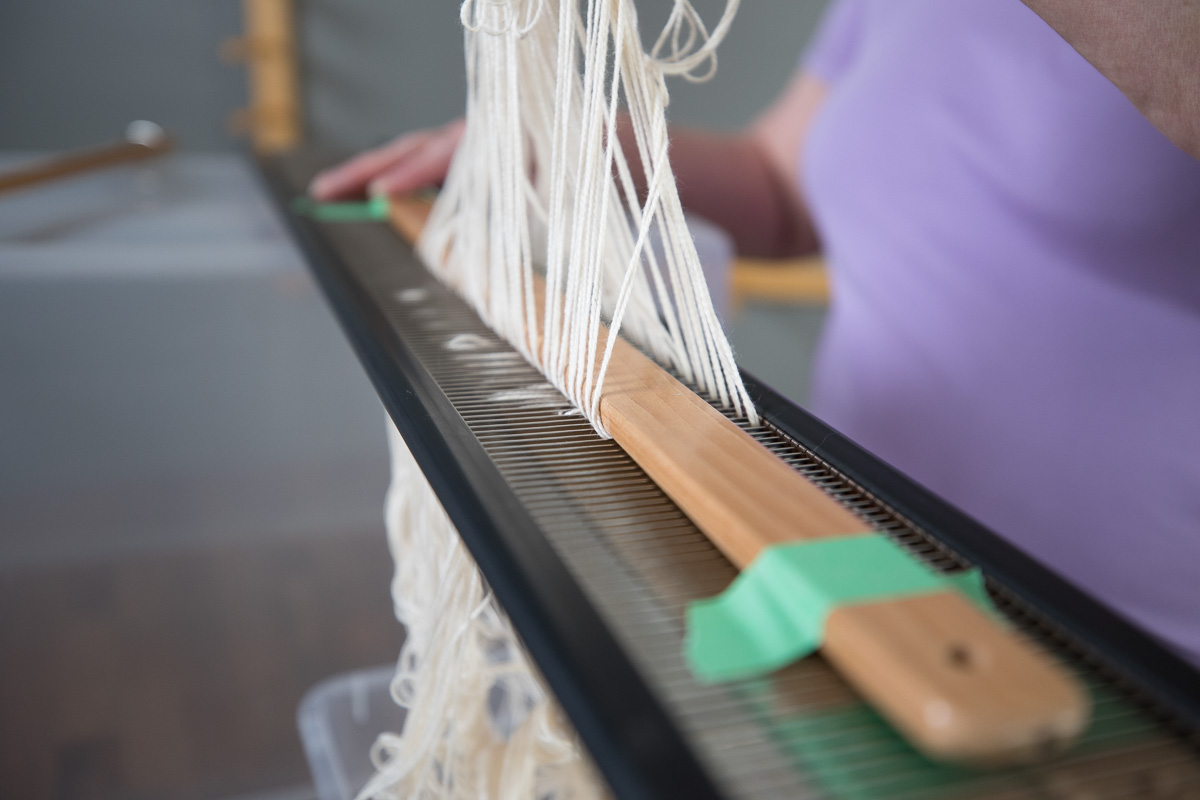 Laura Fry sleying a reed