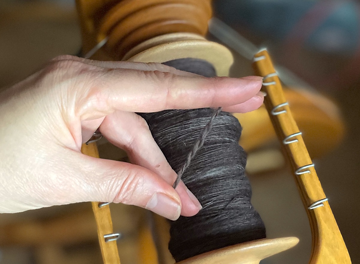 Greta is holding two singles plied to show twist direction 