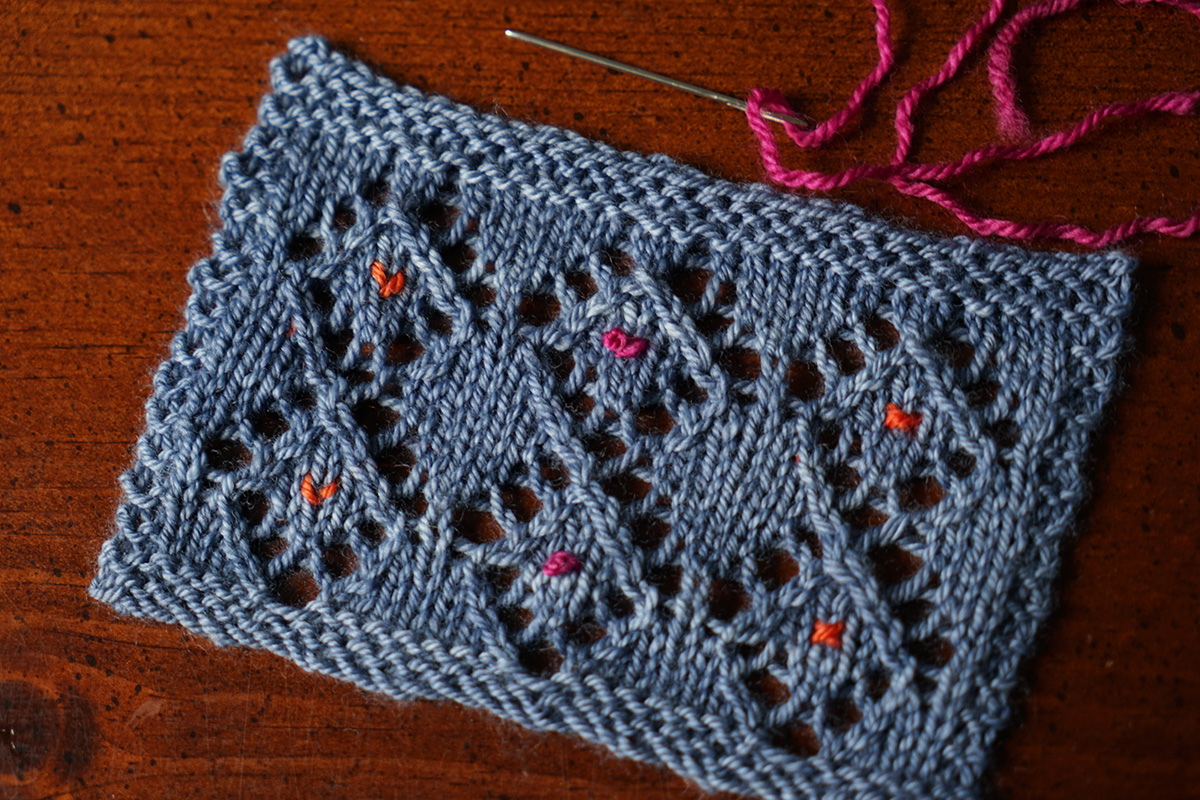 Embroidery on knitted lace fabric