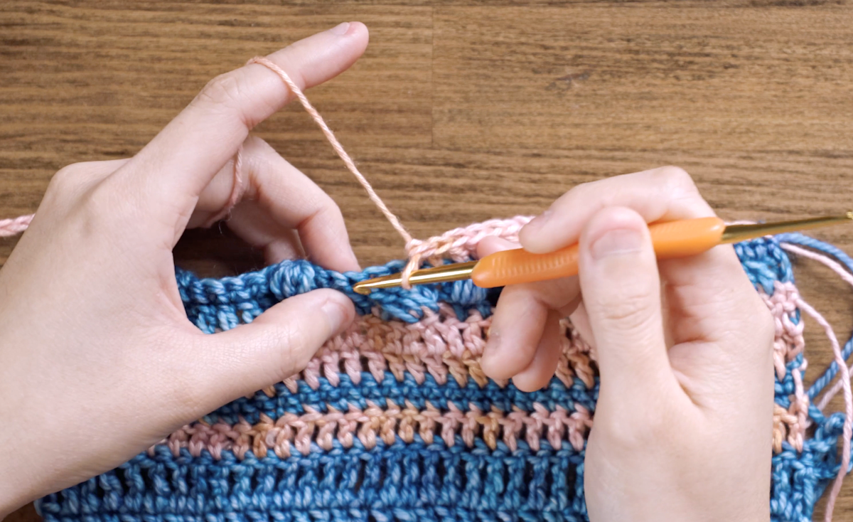And now Charlotte skips two stitches and is about to work a single crochet into the next stitch.