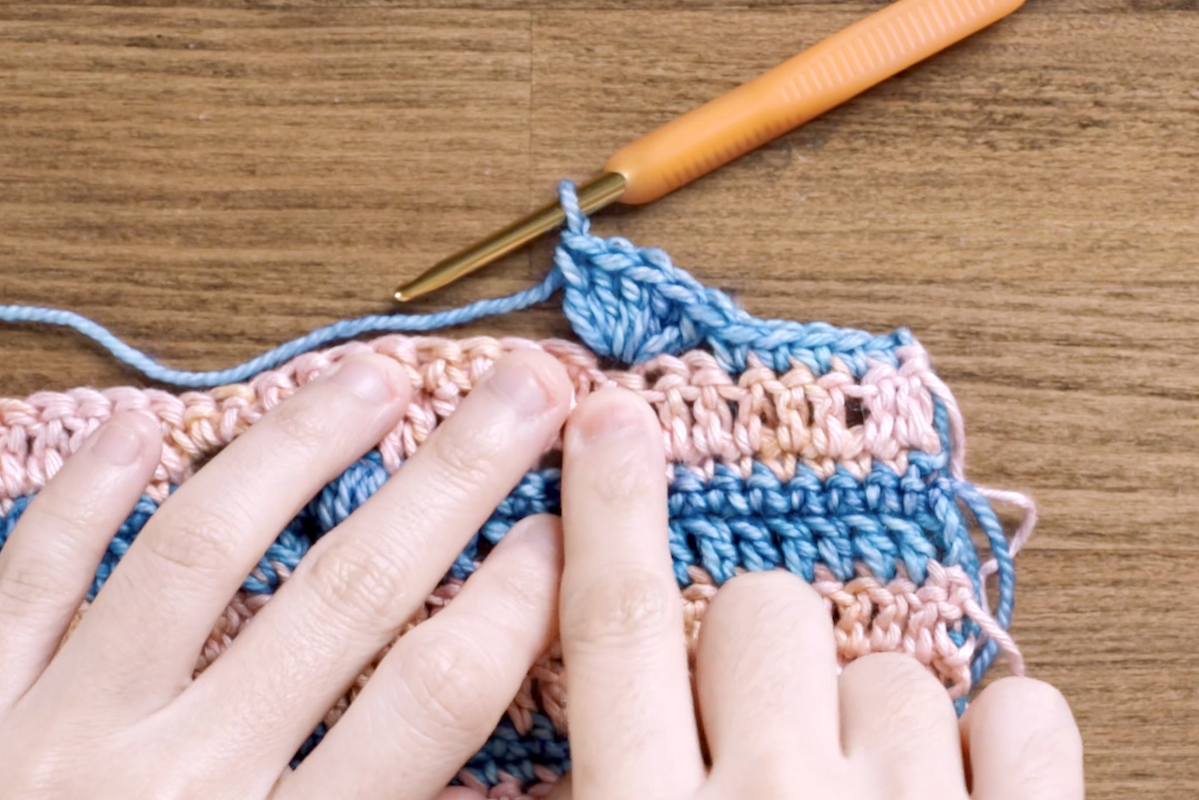 Here, you can see five double crochets (DC) worked into a single stitch, next to the two skipped stitches (SK2).
