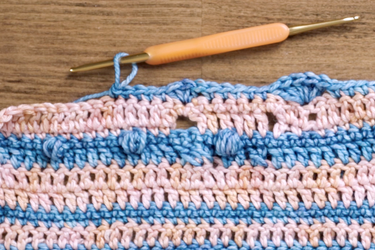 In this variation, Charlotte has worked three half-double crochets (HDC), creating a smaller and more compact fan. 