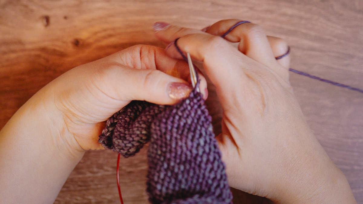 Lever style: The lever action from my right hand brings the working yarn down and around the tip of the right needle.