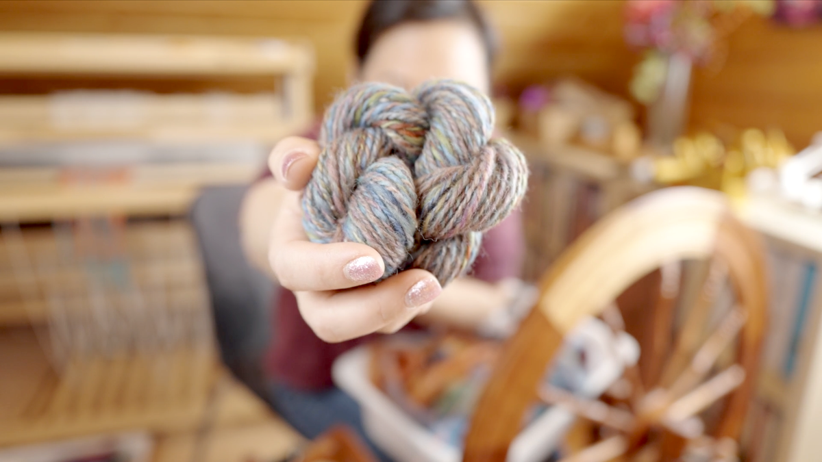 Handspun yarn created from randomly spun and plied rolags.