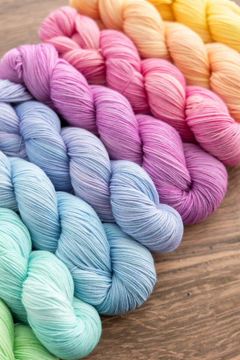 Enlighten Collection yarn skeins hand-dyed on SweetGeorgia Tough Love Sock