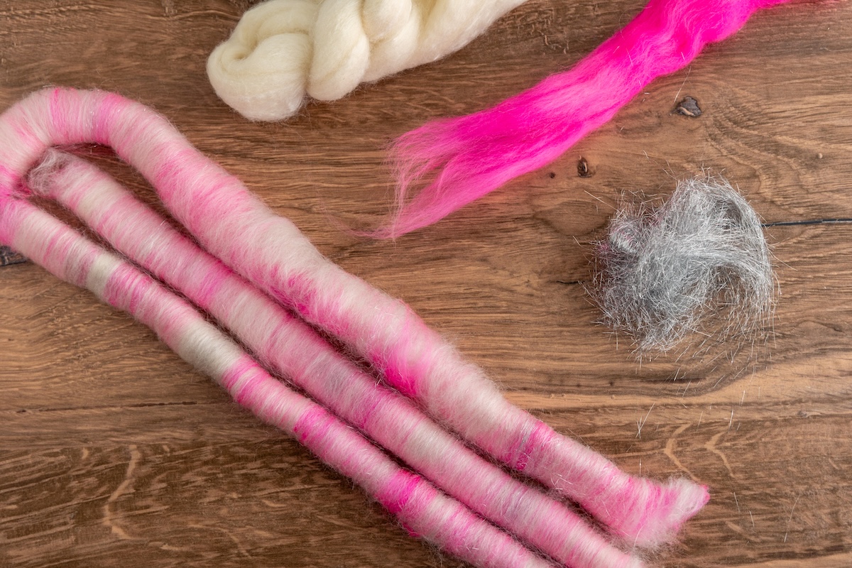 This blend features undyed Bluefaced Leicester, vibrant hot pink Corriedale, and a touch of Angelina, creating a mix that looks almost like candy!
