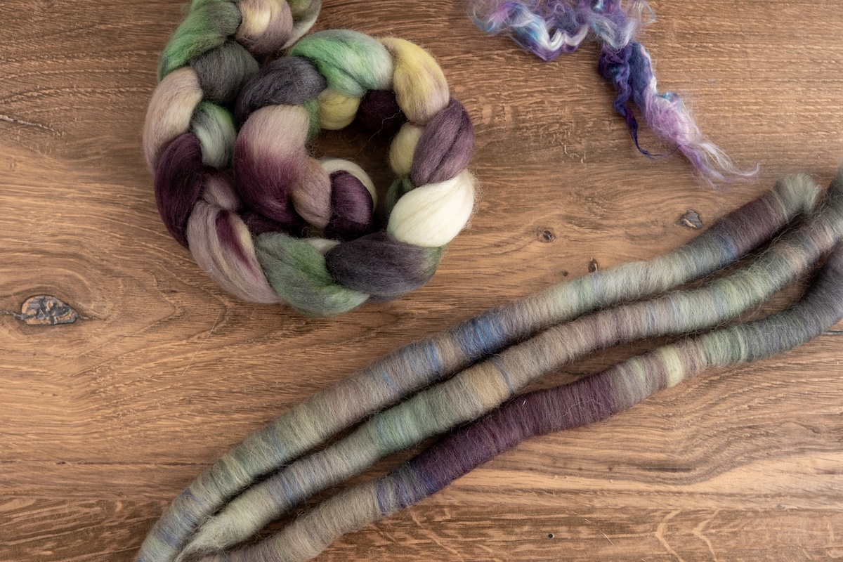 This hand-dyed silk softly enhances and blends with the colours of the SweetGeorgia Shadows on Snow colourway on Corriedale fibre, creating a seamless harmony, as if the silk was always meant to be part of the mix.