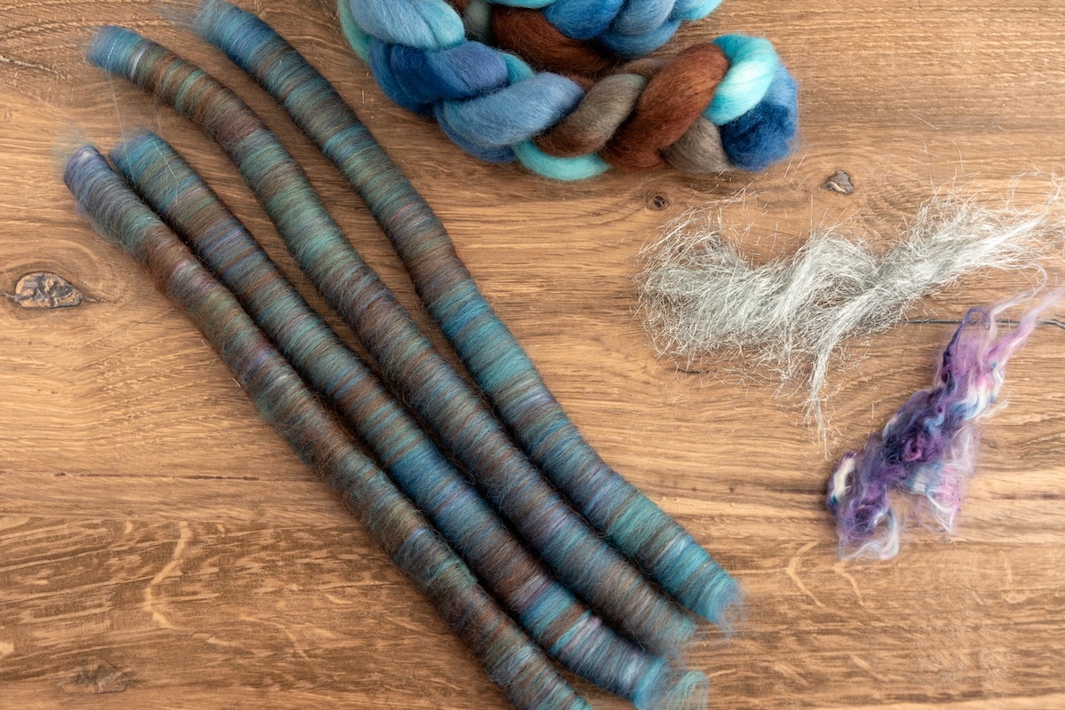 These rolags are from the SweetGeorgia River Walk colourway on Corriedale, blended with Angelina and silk, creating rolags that will absolutely beam when spun!