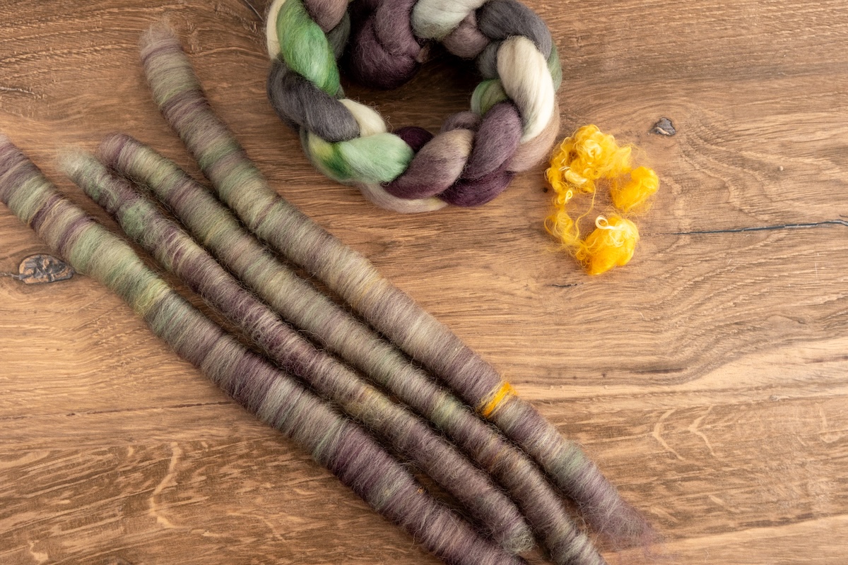 Although you can only see one band of mohair, keep in mind that rolags are spirals of fibre, meaning the locks will be rolled through and spring out beautifully when spun. These rolags are made from the Shadows on Snow colourway on Corriedale fibre.