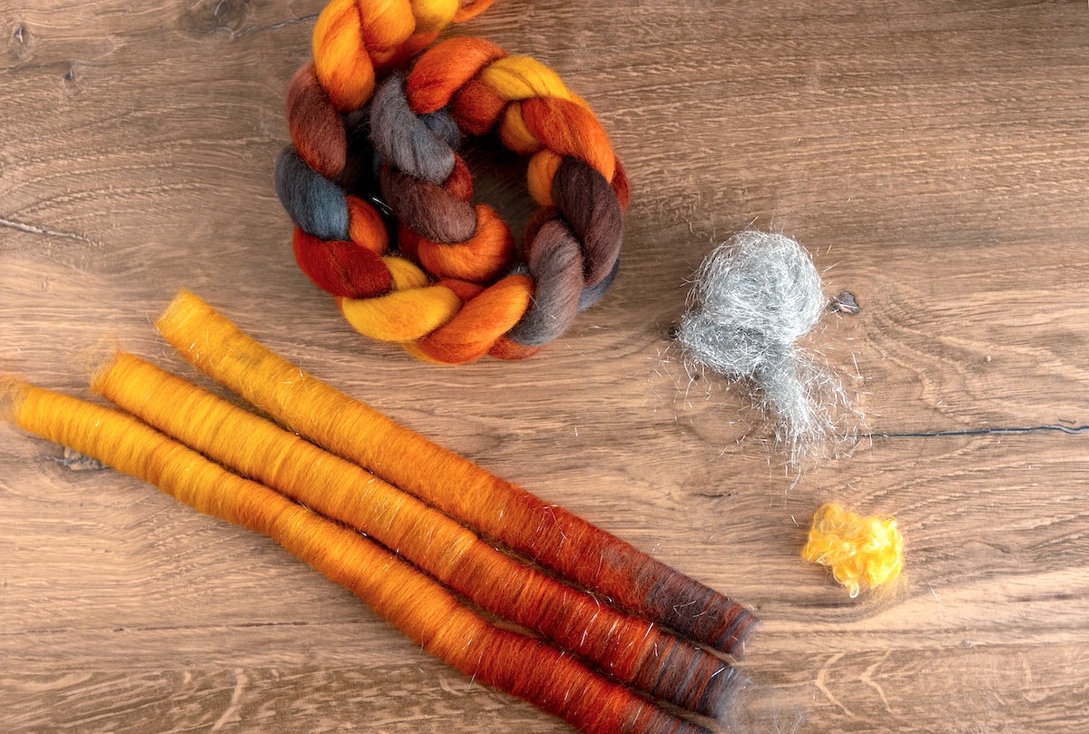 These rolags, prepared with SweetGeorgia’s Winter Skies colourway, are a blend of Corriedale fibre, Angelina, and mohair locks, giving a touch of sparkle and texture.