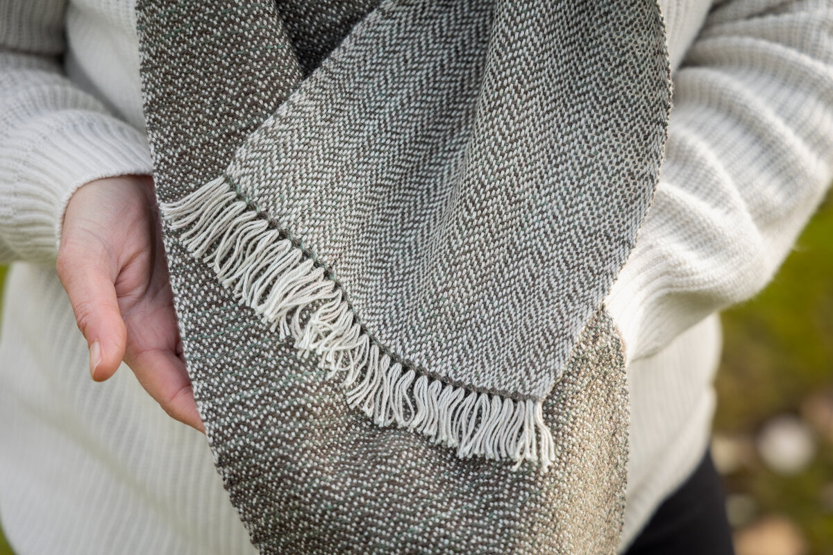 Close up of the hemstitching and ends of the Fraser Scarf weaving design by Amanda Wood in earthy green hues by SweetGeorgia Yarns