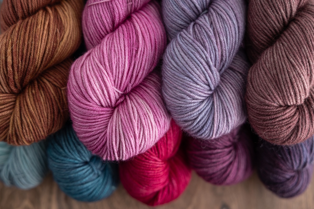 Group of hand-dyed DK-weight yarn skeins 