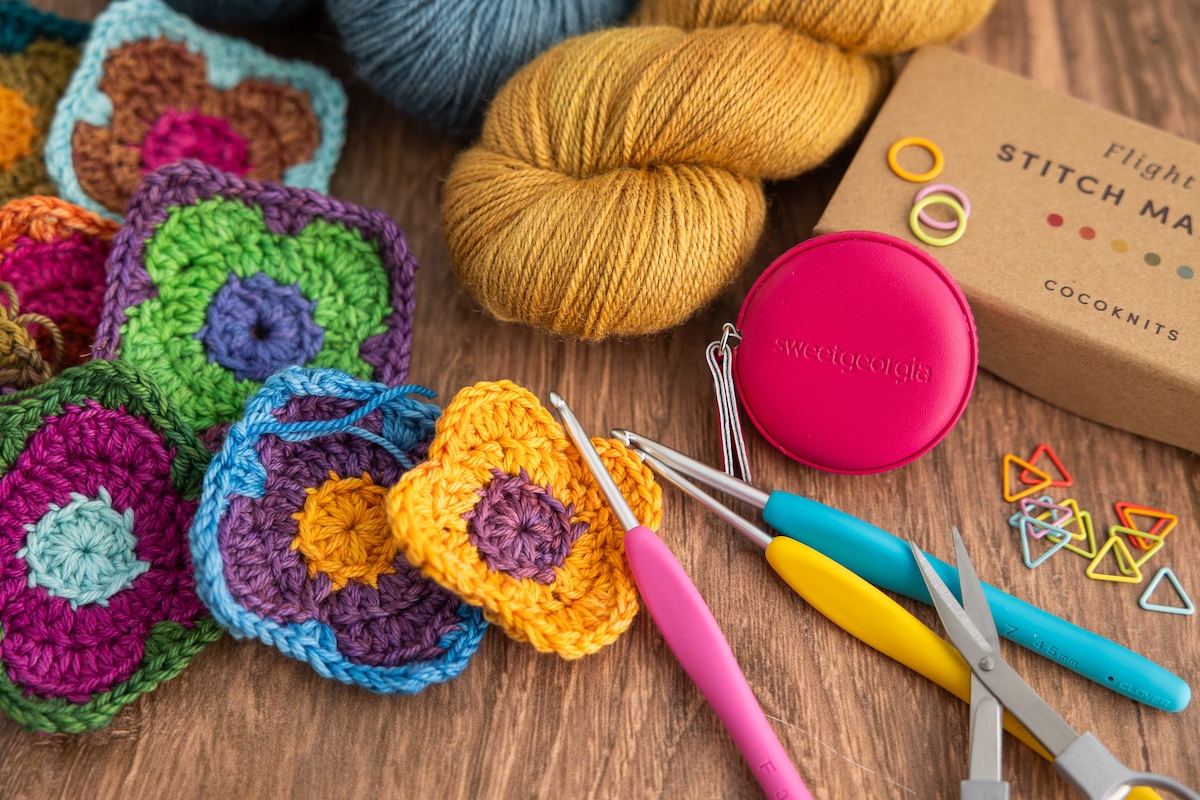 Various crochet tools and accessories with SweetGeorgia BFL+Silk yarn