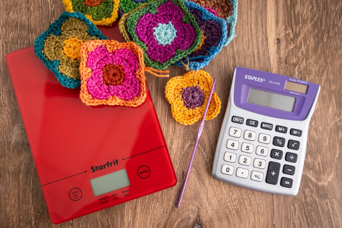 Crochet granny squares, digital scale, and calculator