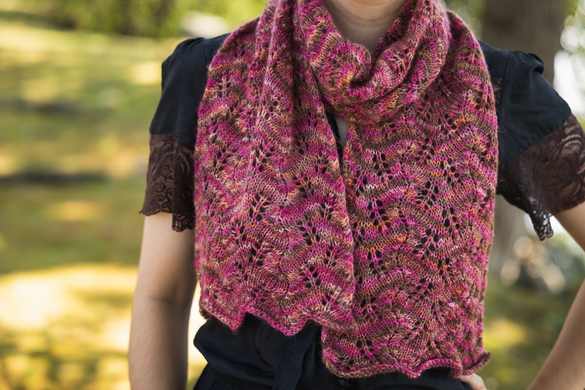 Close up of lace knit scarf knit in hand dyed yarn