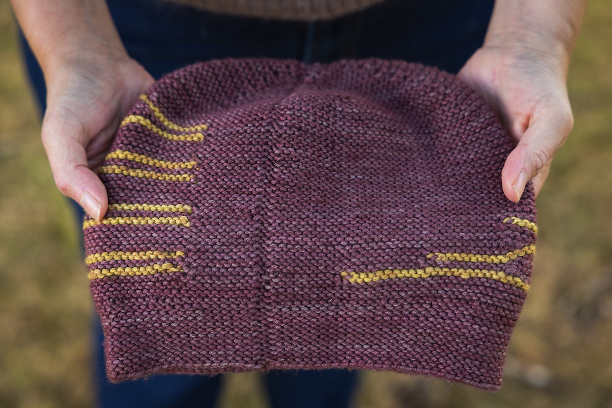 Construction of a striped, knit flat hat