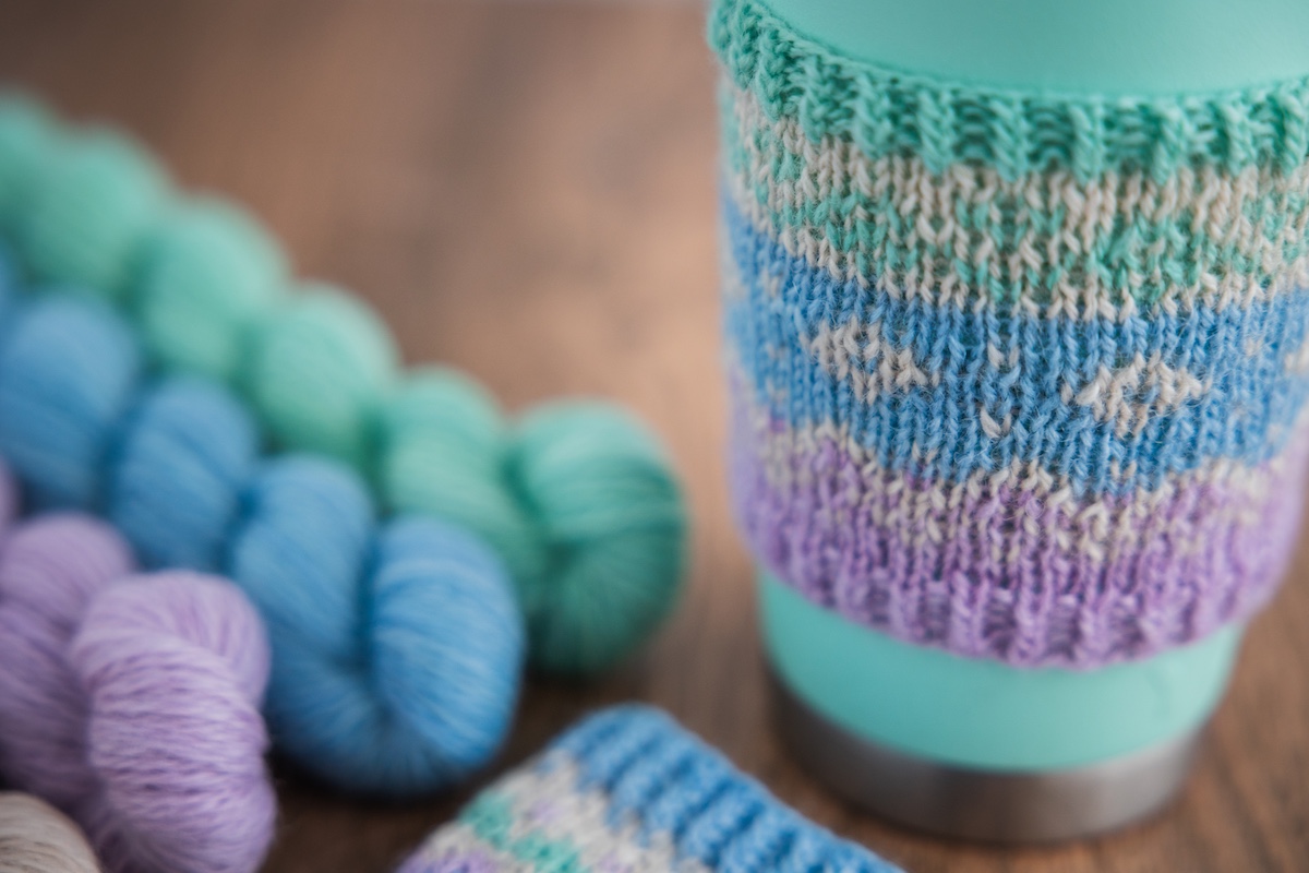 Knit mug cozy using Secret Stash Club yarn mini-skeins