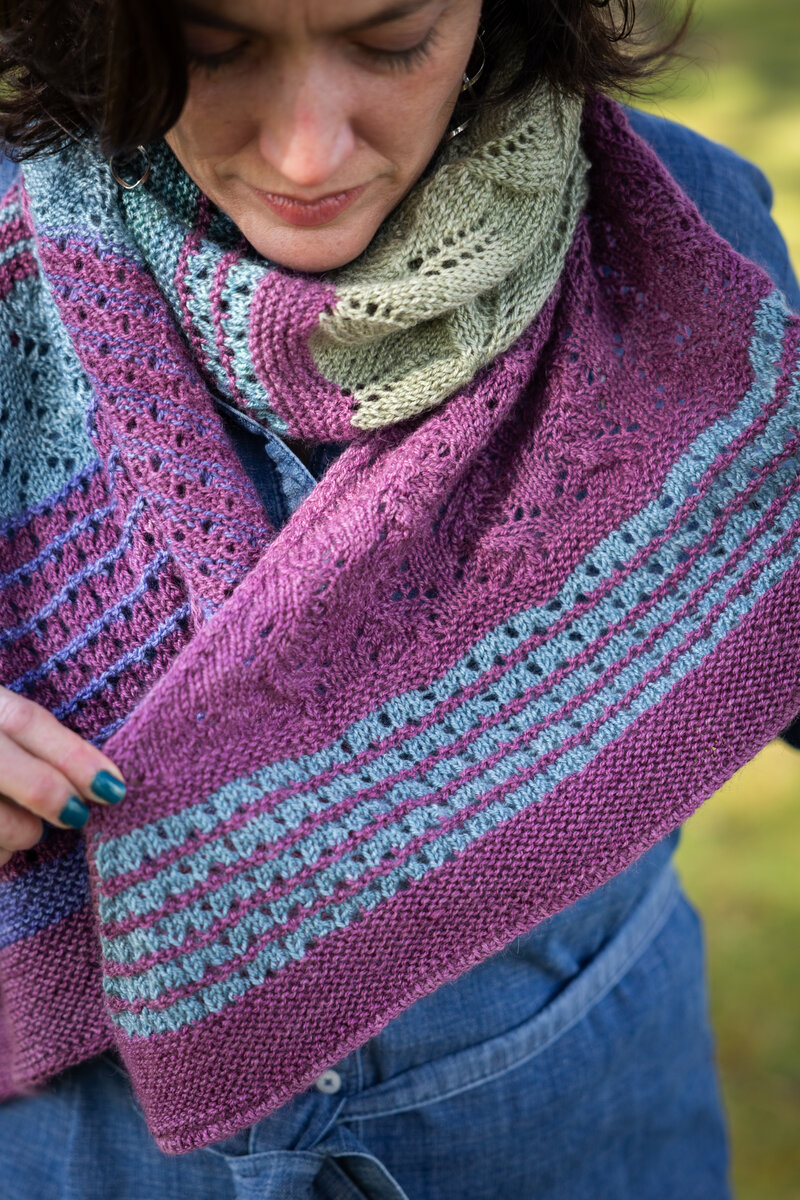 Design by Charlotte Lee Knit in Trifecta Fine Black Raspberry (MC) and Lavender, Mermaid, Blue Canoe, Clearwater, and Sage (CC) Summer Spectra KAL 2026 Pattern