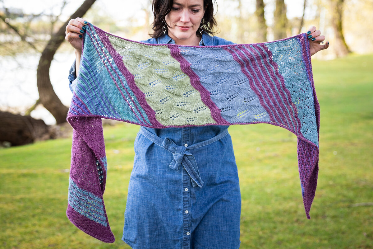 Design by Charlotte Lee
Knit in Trifecta Fine Black Raspberry (MC) and Lavender, Mermaid, Blue Canoe, Clearwater, and Sage (CC)

Summer Spectra KAL 2026 Pattern